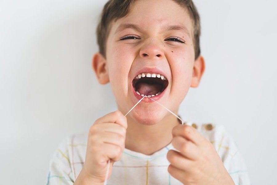 A child learning to floss